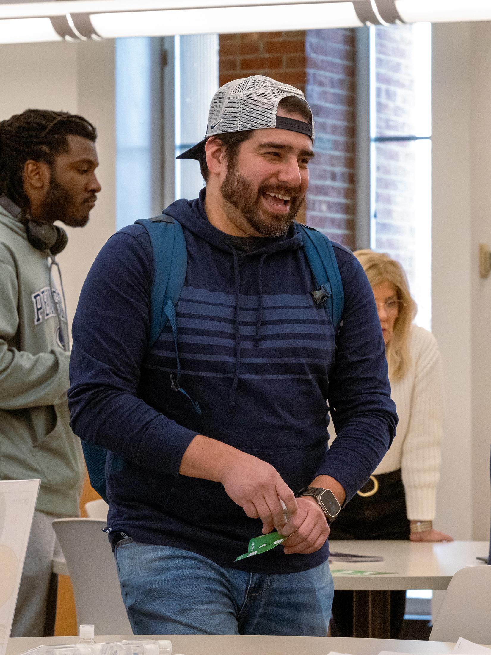 A student smiles while walking through the library during the Financial Literacy event.