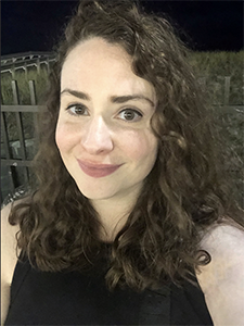 A self-taken photo of a woman outside.
