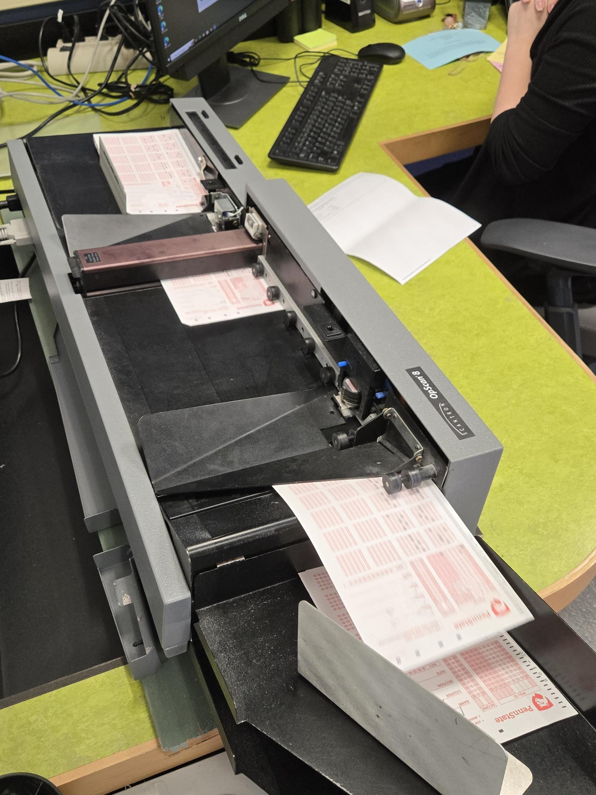 Exam sheets going through a scanning machine