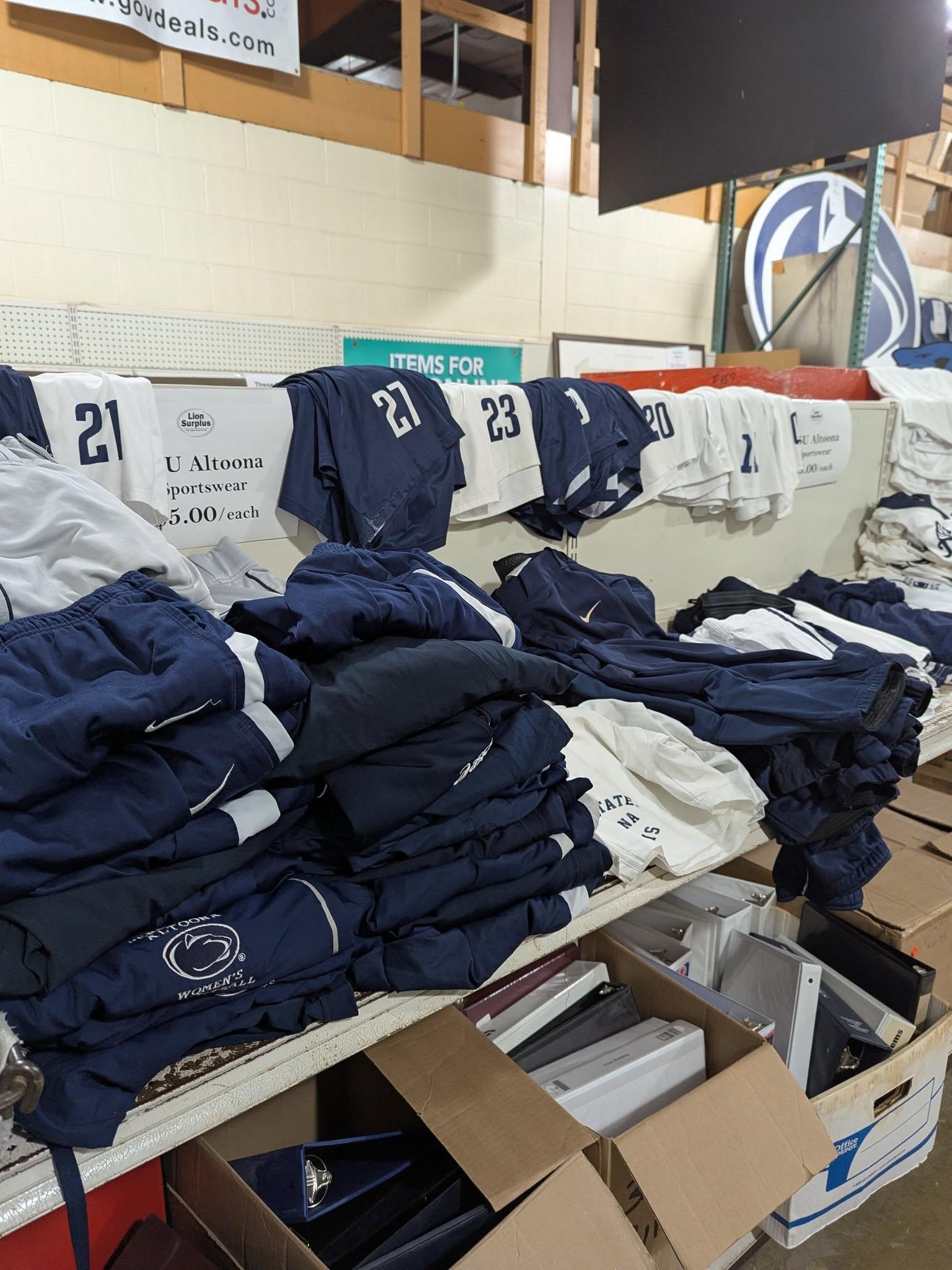Rows of folded Penn State merchandise