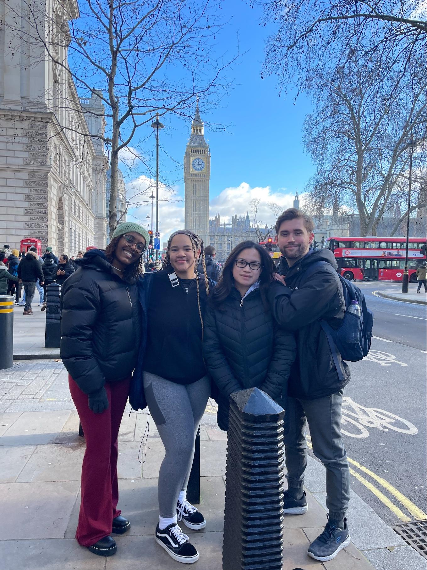 A group of students smiling on a street
