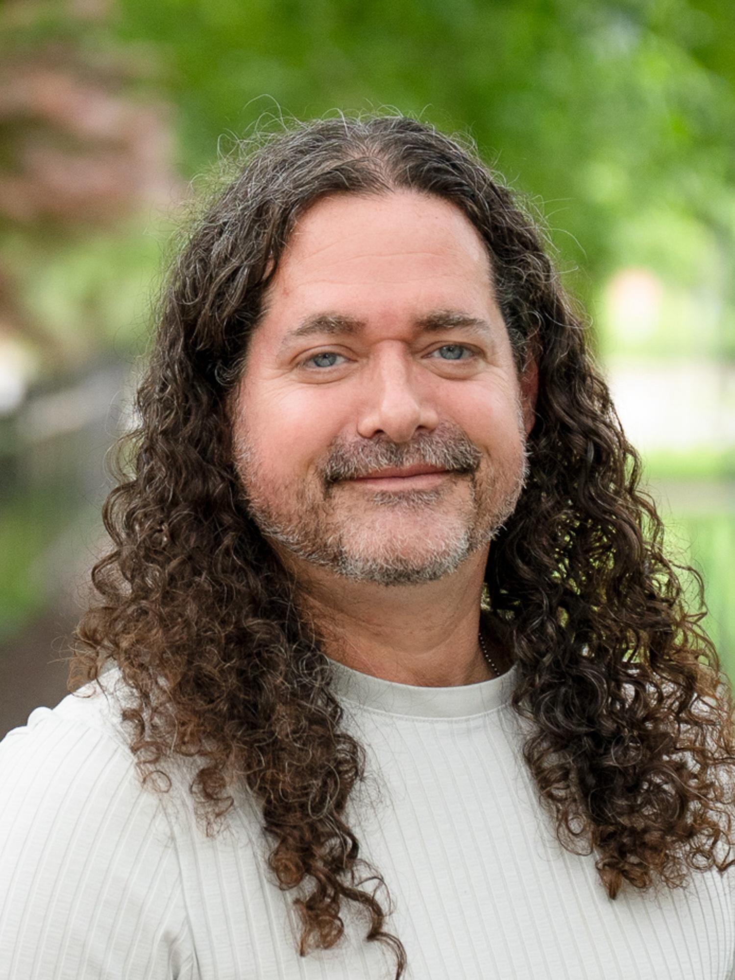 A headshot photo of Craig A. Miller