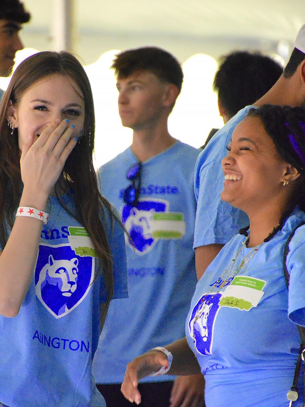 Two students in Abington shirts laughing