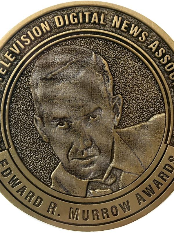 A medallion withe profile of a man in a coat and tie