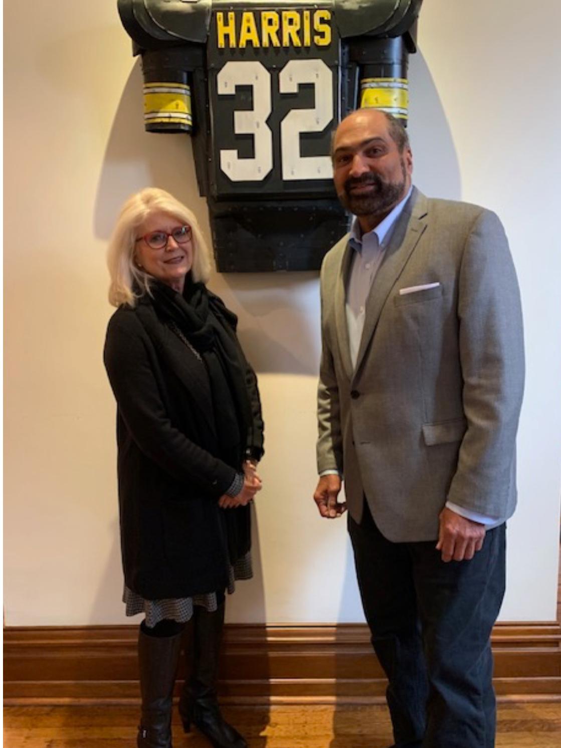 Franco and Dana Harris standing in front of #32 Pittsburgh Steelers jersey.