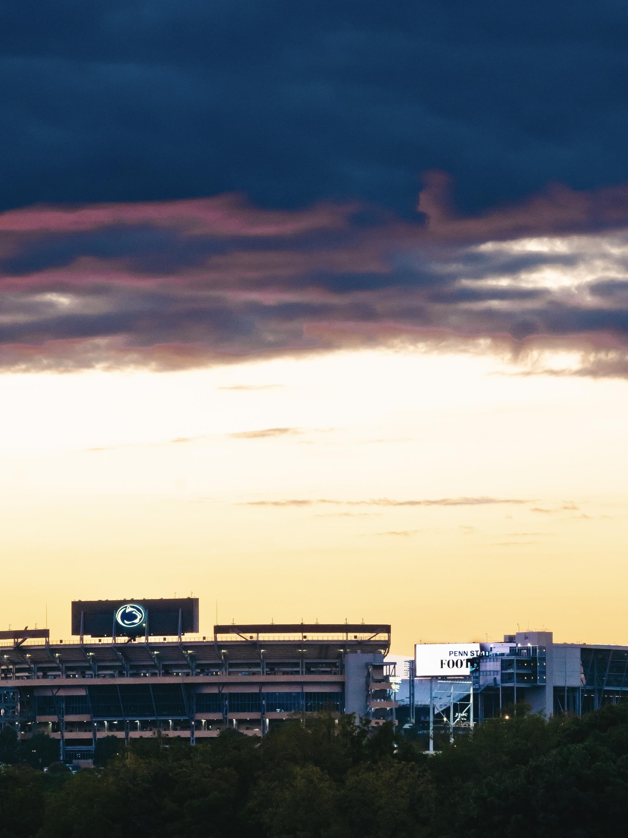 A picture of Beaver Stadium under a clouded sunset