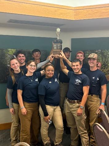 The Mont Alto Woodsmen's Team holds up the team trophy