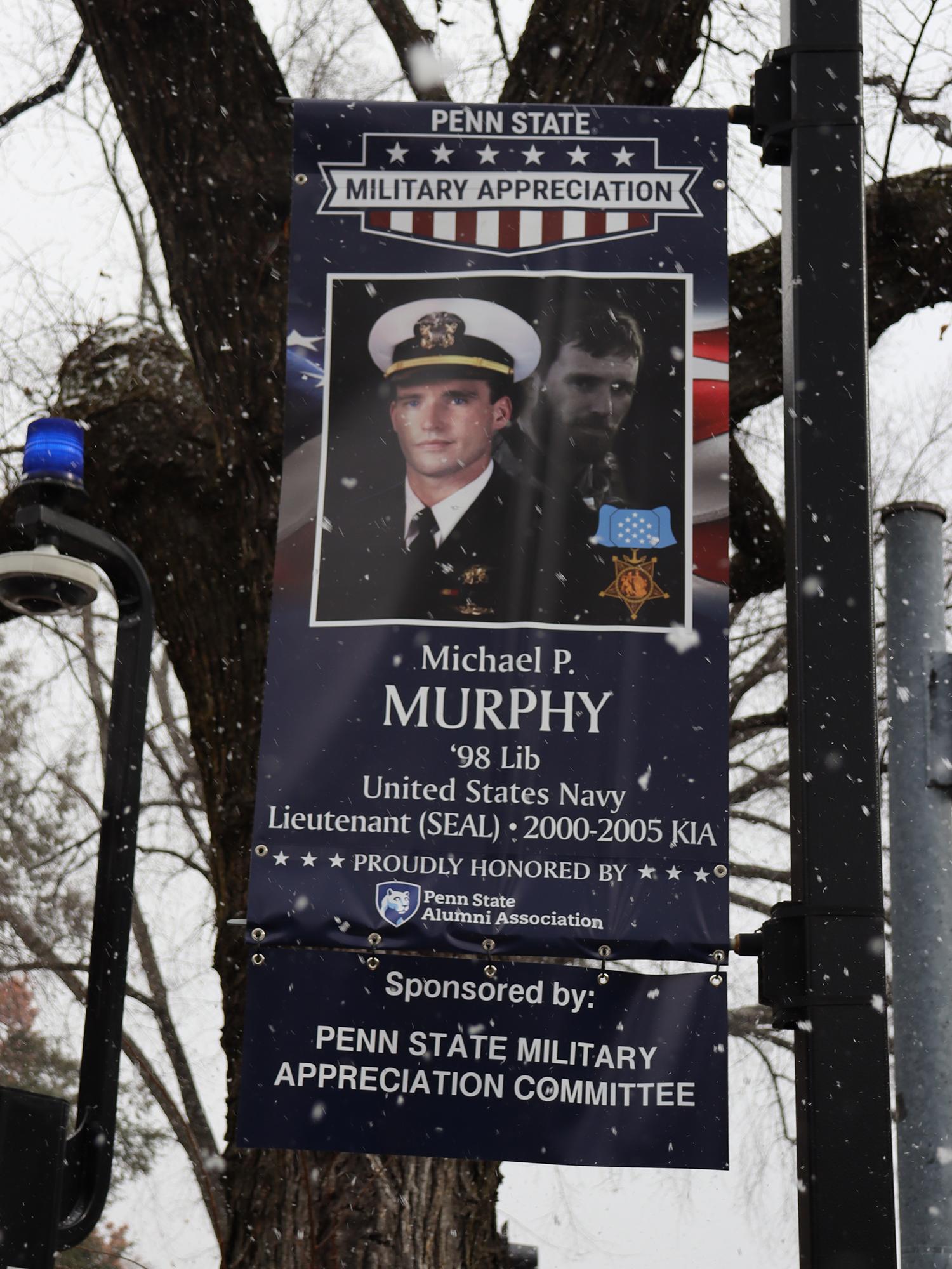 A red, white, and blue banner with a man's photo.