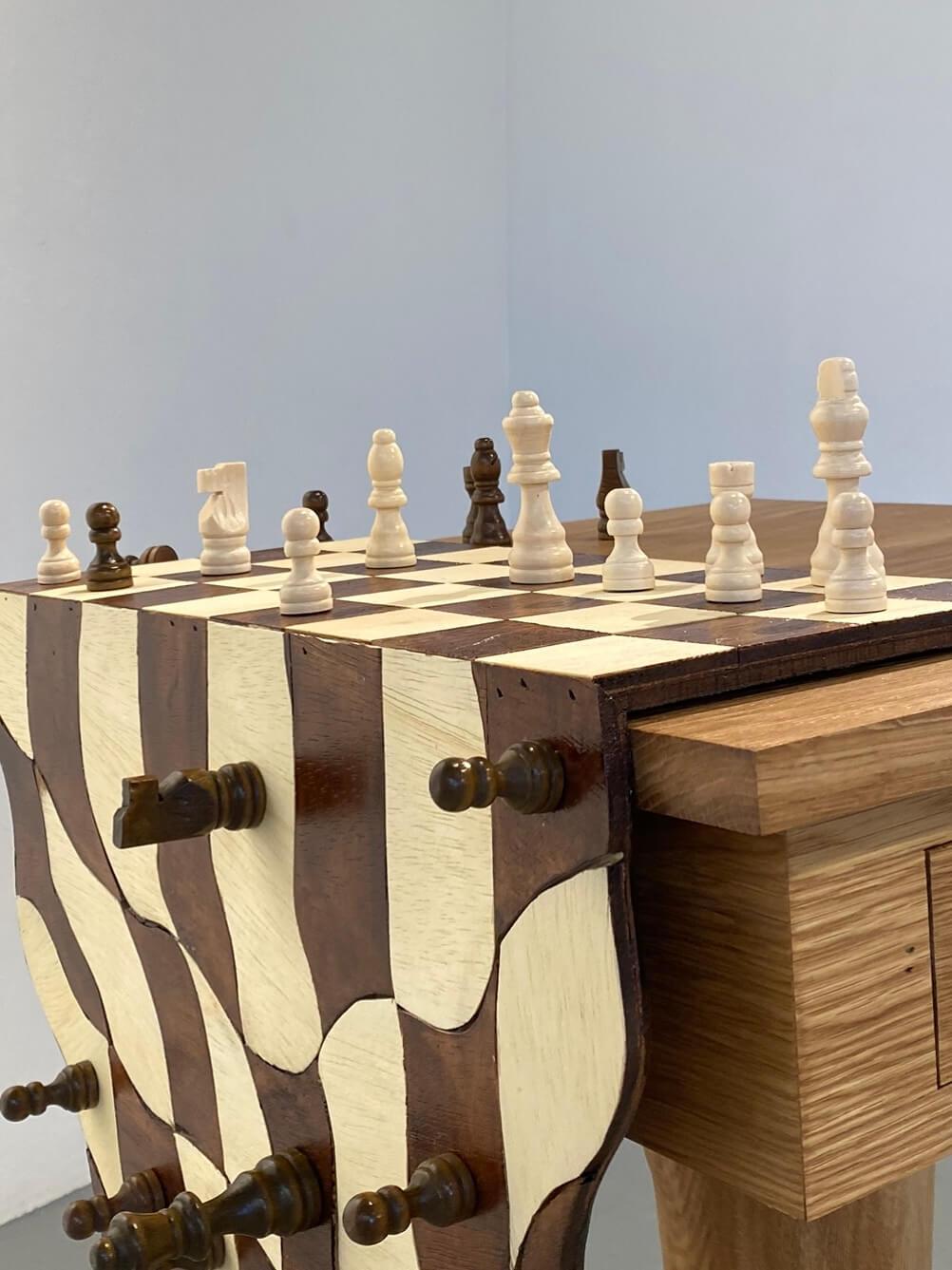 Artwork showing a chessboard sliding off of a table
