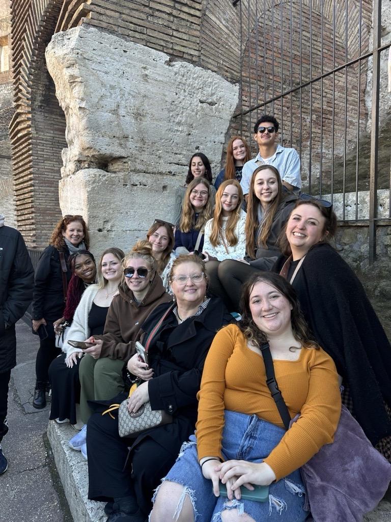 A group of students pose for a picture in Italy