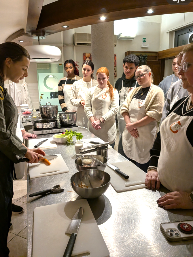 Students watch a chef demonstrate during a cooking class