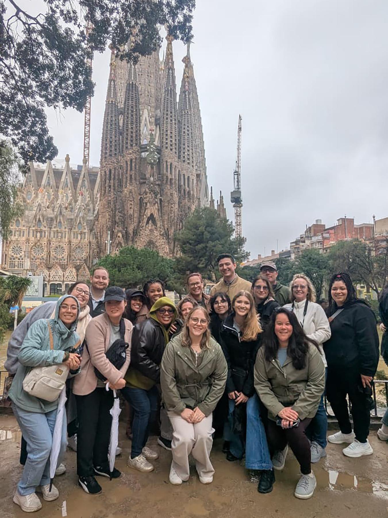 A group of people stand in front of a large church.