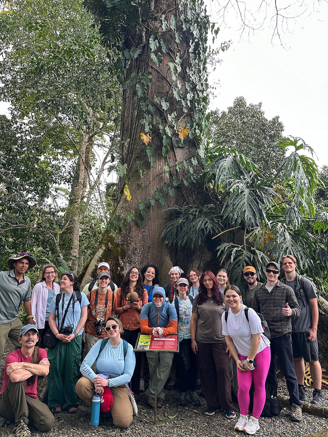 A group of people posing in front of a Ceiba tree in Costa Rica