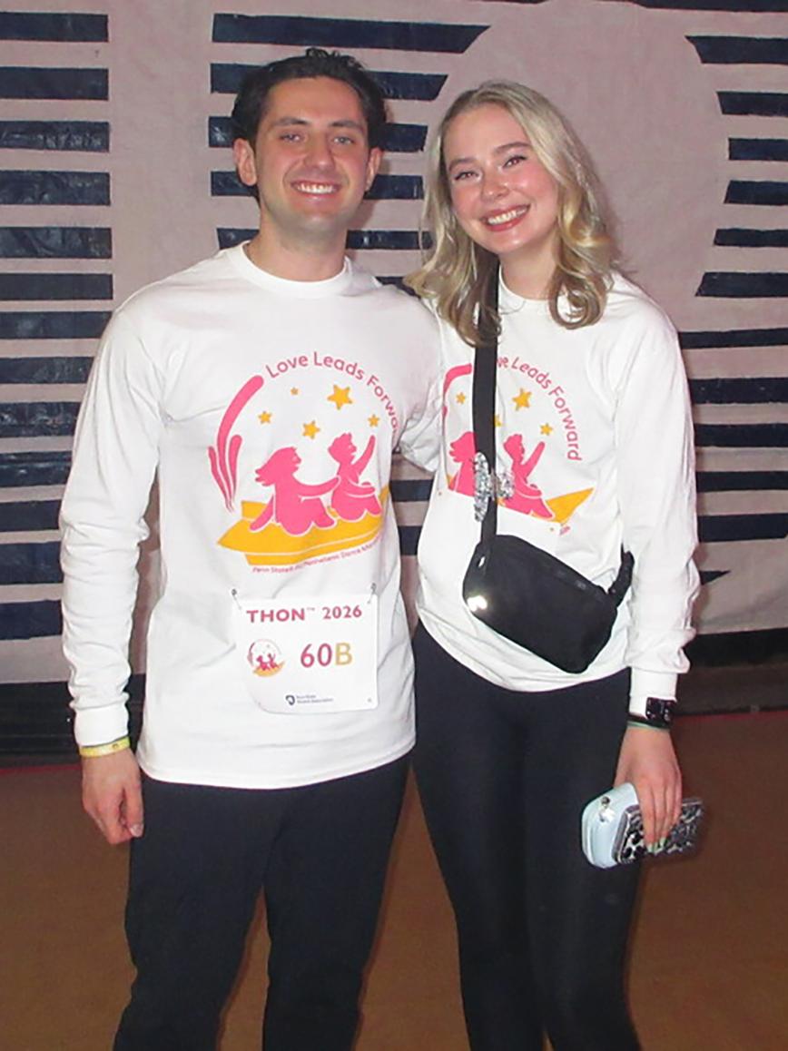 John Papadopolous poses with a friend wearing THON T-shirts.