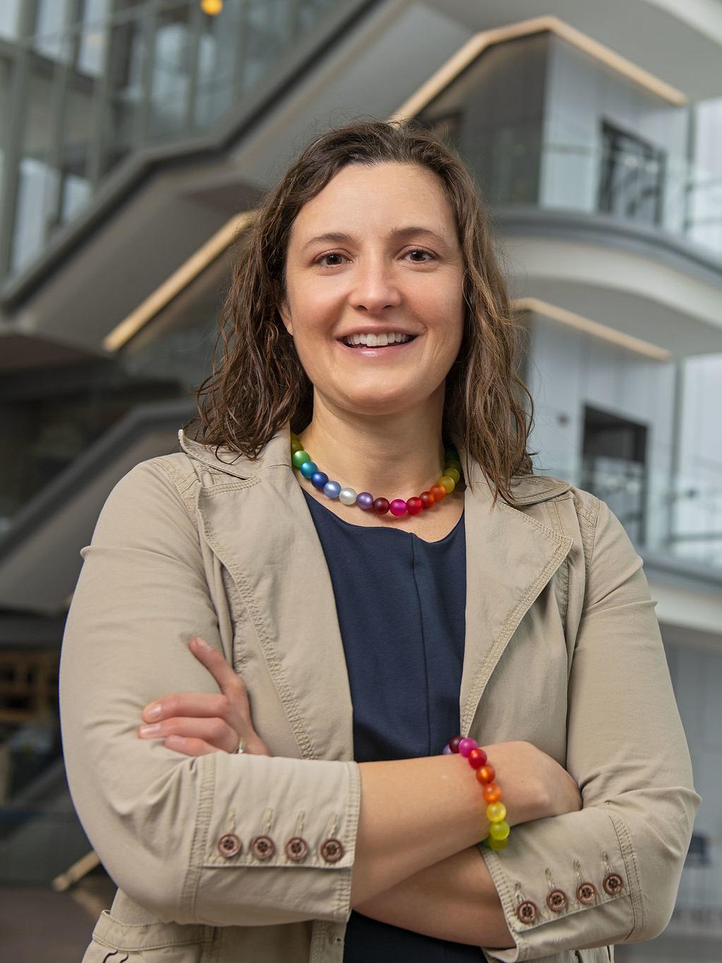 Karen Winterich stands in the Business Building atrium with the steps in the background.