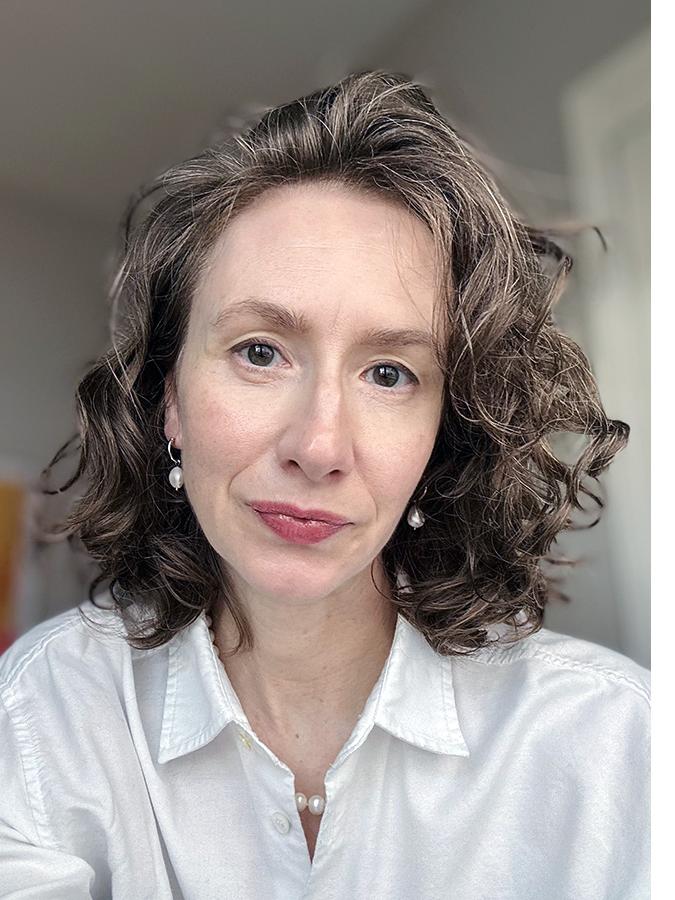 Kate Merkel-Hess wearing a white blouse. 