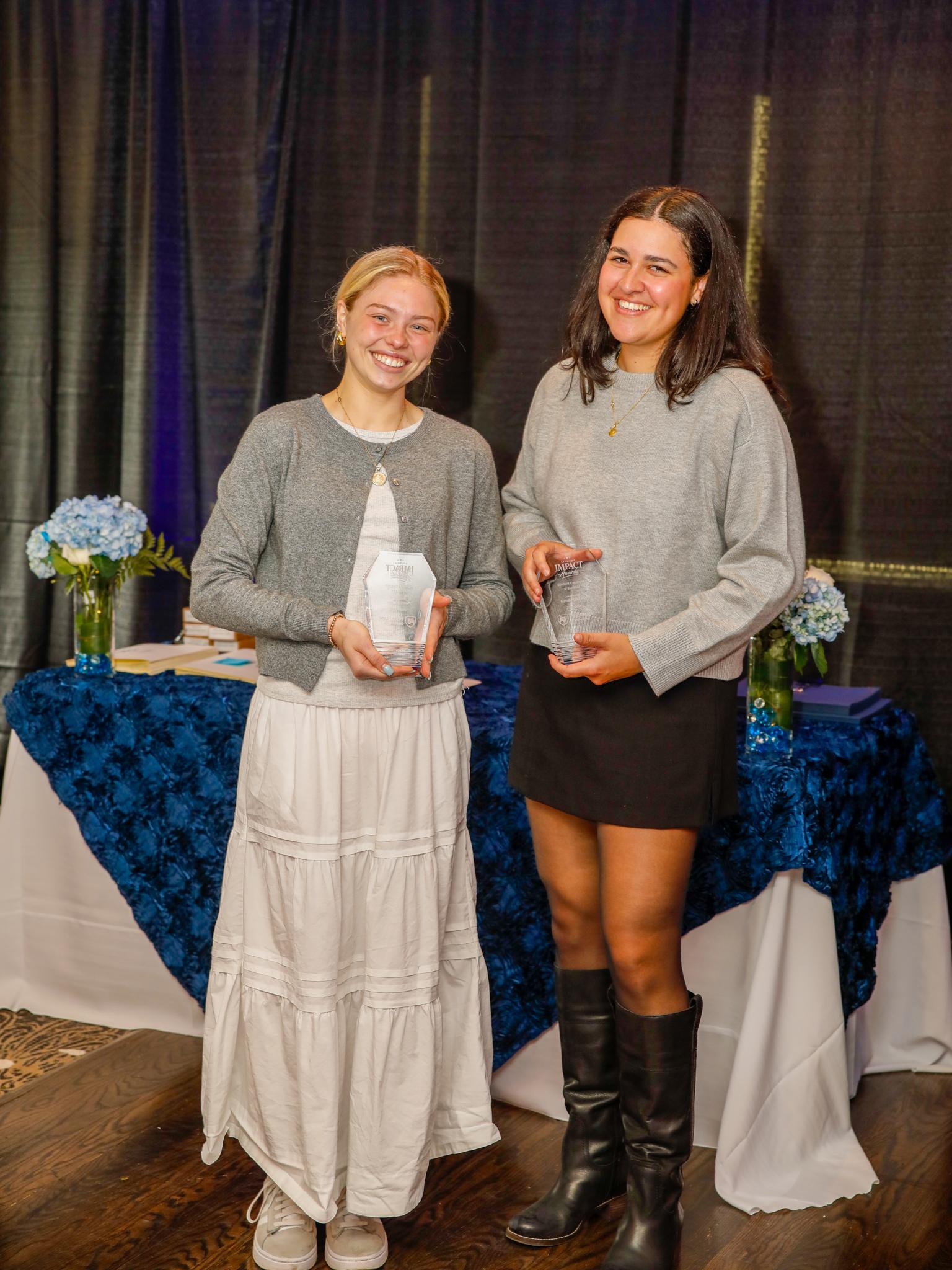 Ava Clements and Natalie DiMario holding plaques