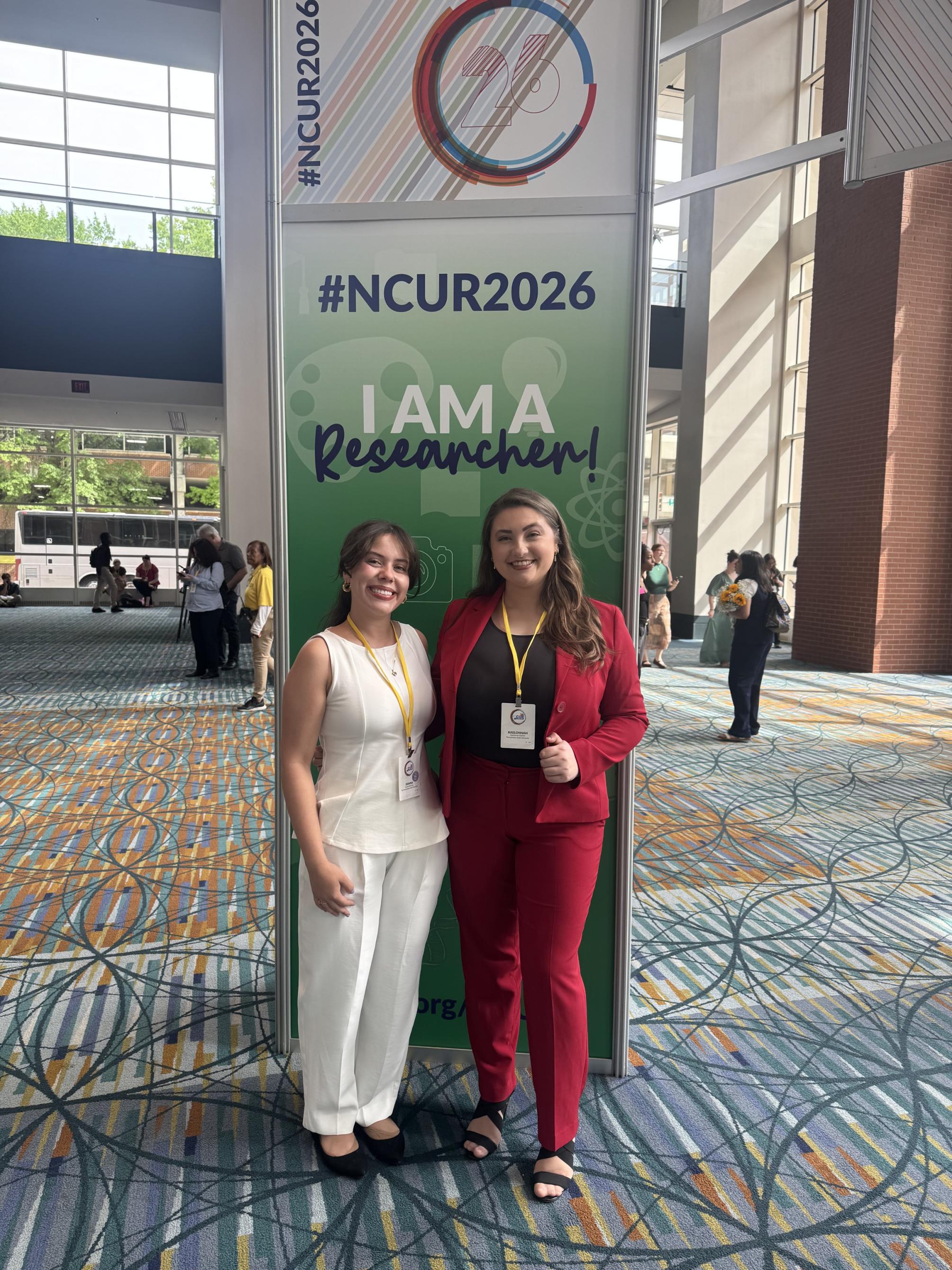 Donna Hercules and Kaelonnah Darlich posing in conference center