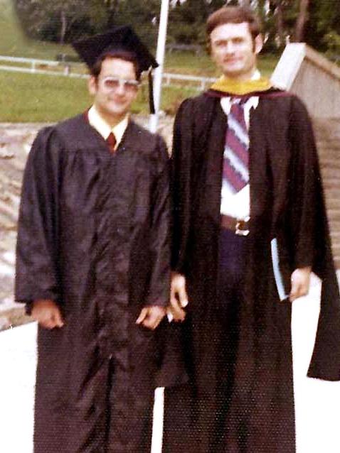 Ed lucy and richard dempsey, wearing their commencement caps and gowns, pose for a photo