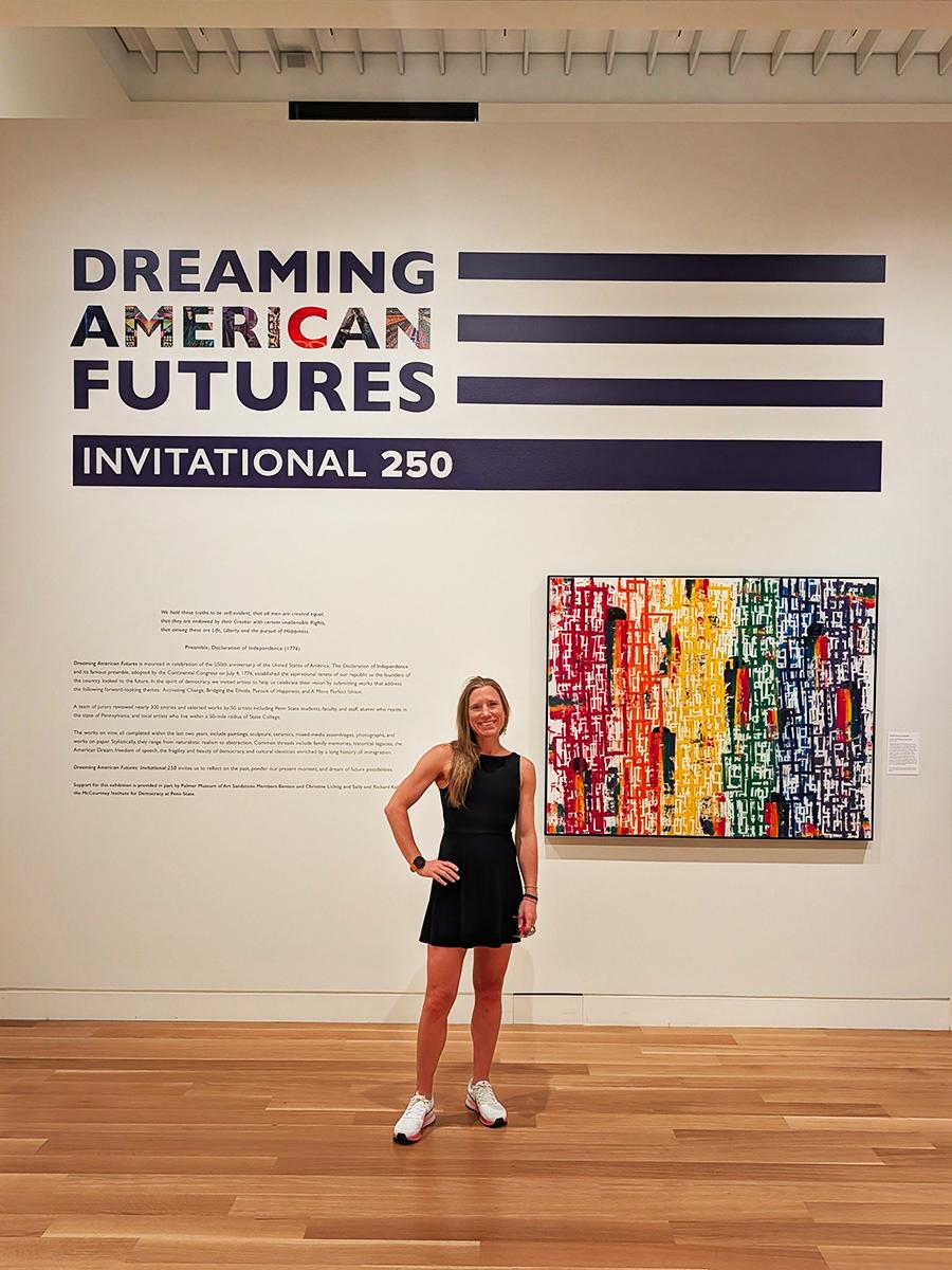 Heidi Manfred stands in front of a piece of her art at an exhibit at Penn State's Palmer Museum of Art