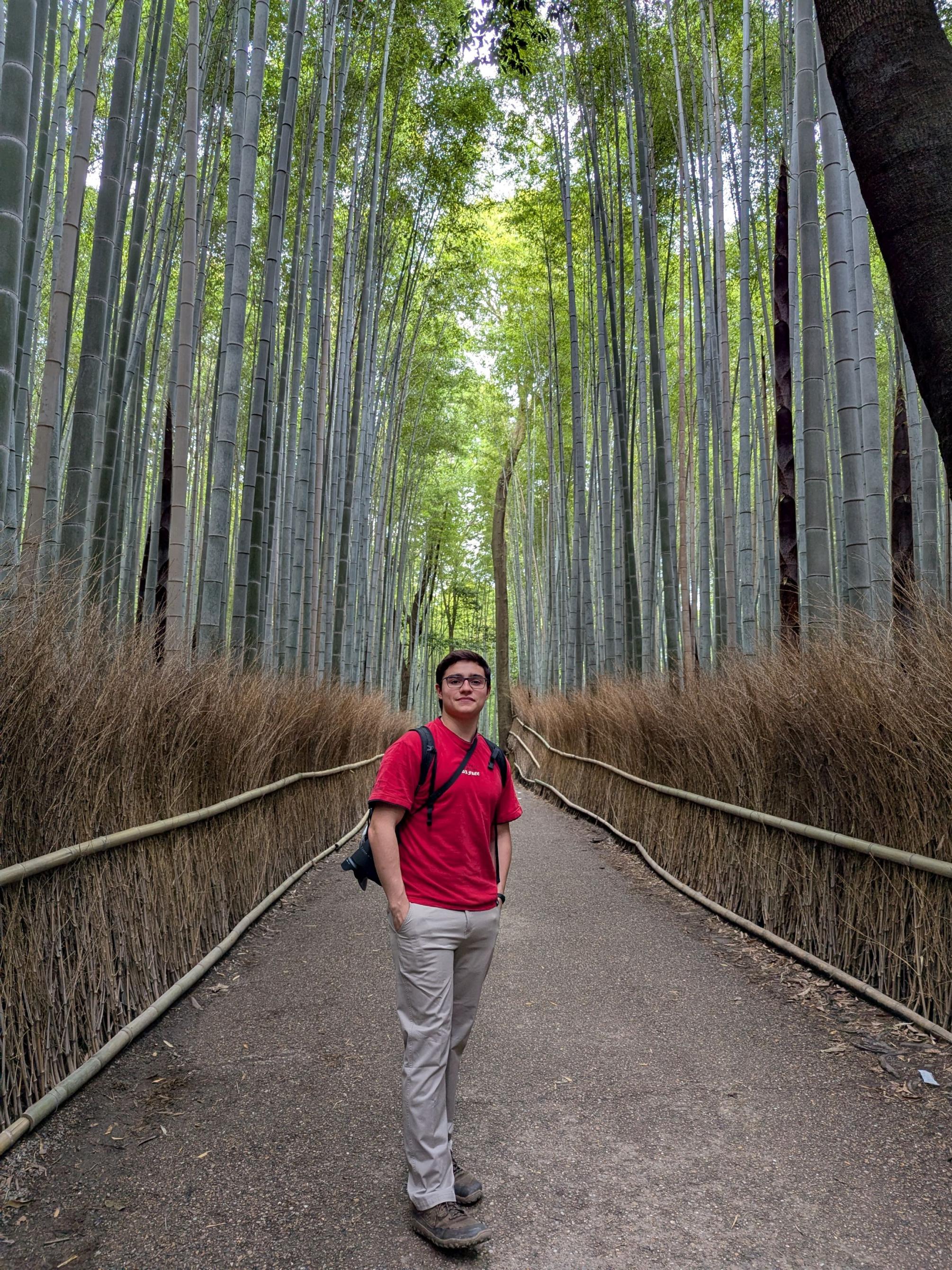 Matias Moreno standing on gravel path in a bamboo forest