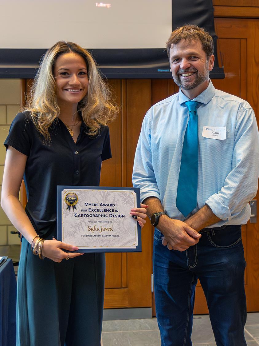 Safia Javed stands with Chris Fowler while receiving the Myers Award for Cartographic Excellence.