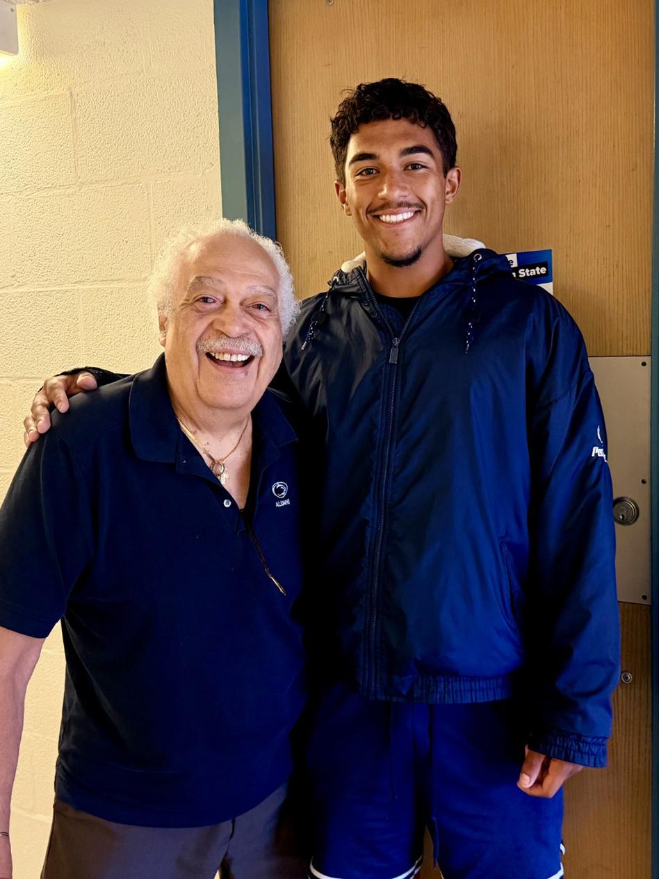 John Robinson, also known as "the Penn State Pop Pop," embraces his grandson Wes Robinson during move-in day at Beaver Hall on the University Park campus