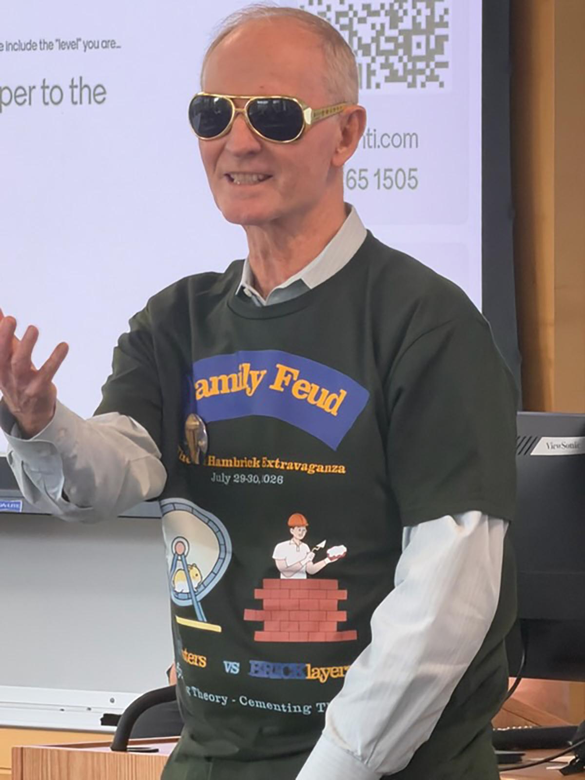 Don Hambrick gestures as he wears a specially designed T-shirt and a pair of sunglasses
