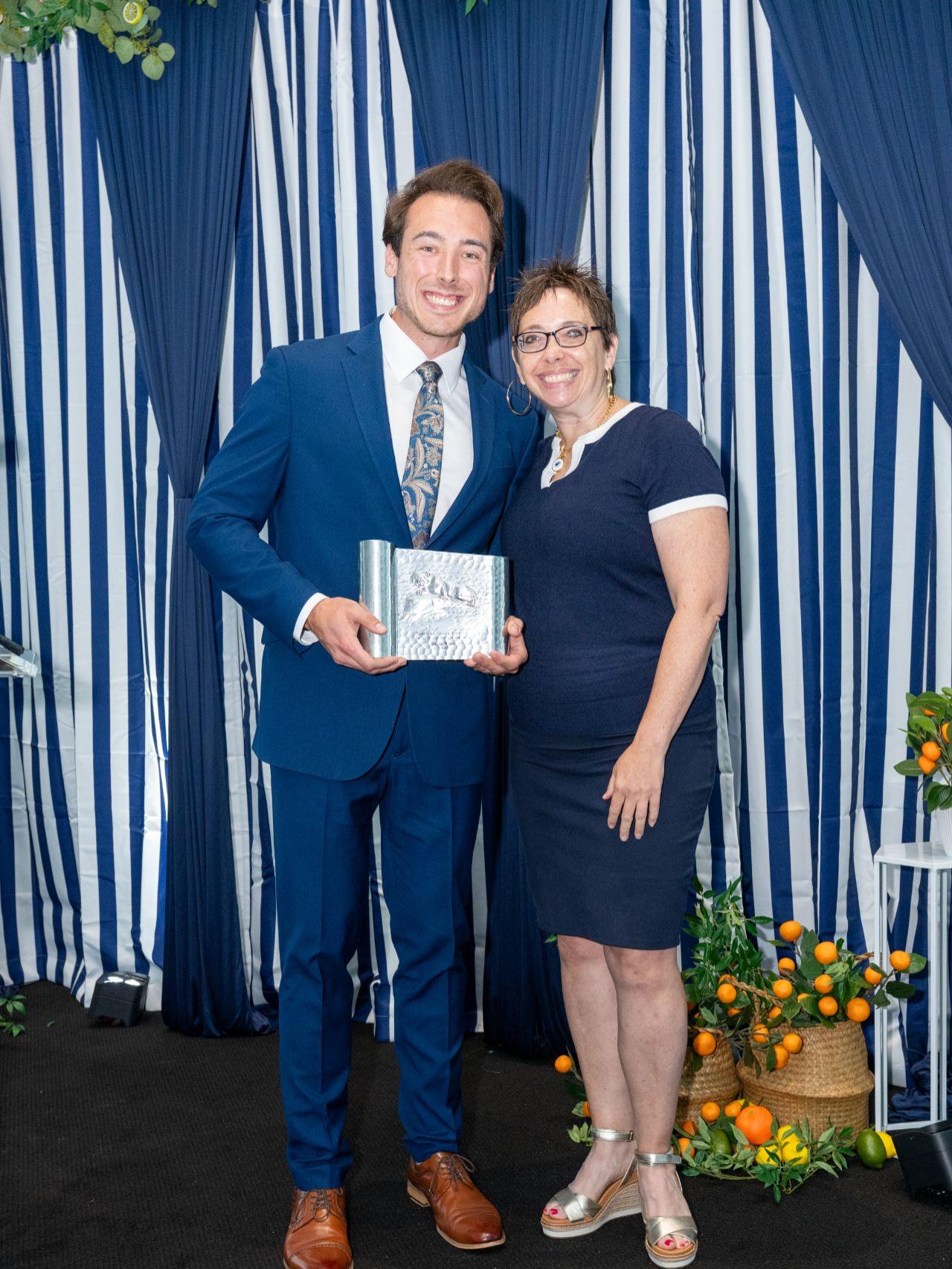 two people standing on a stage