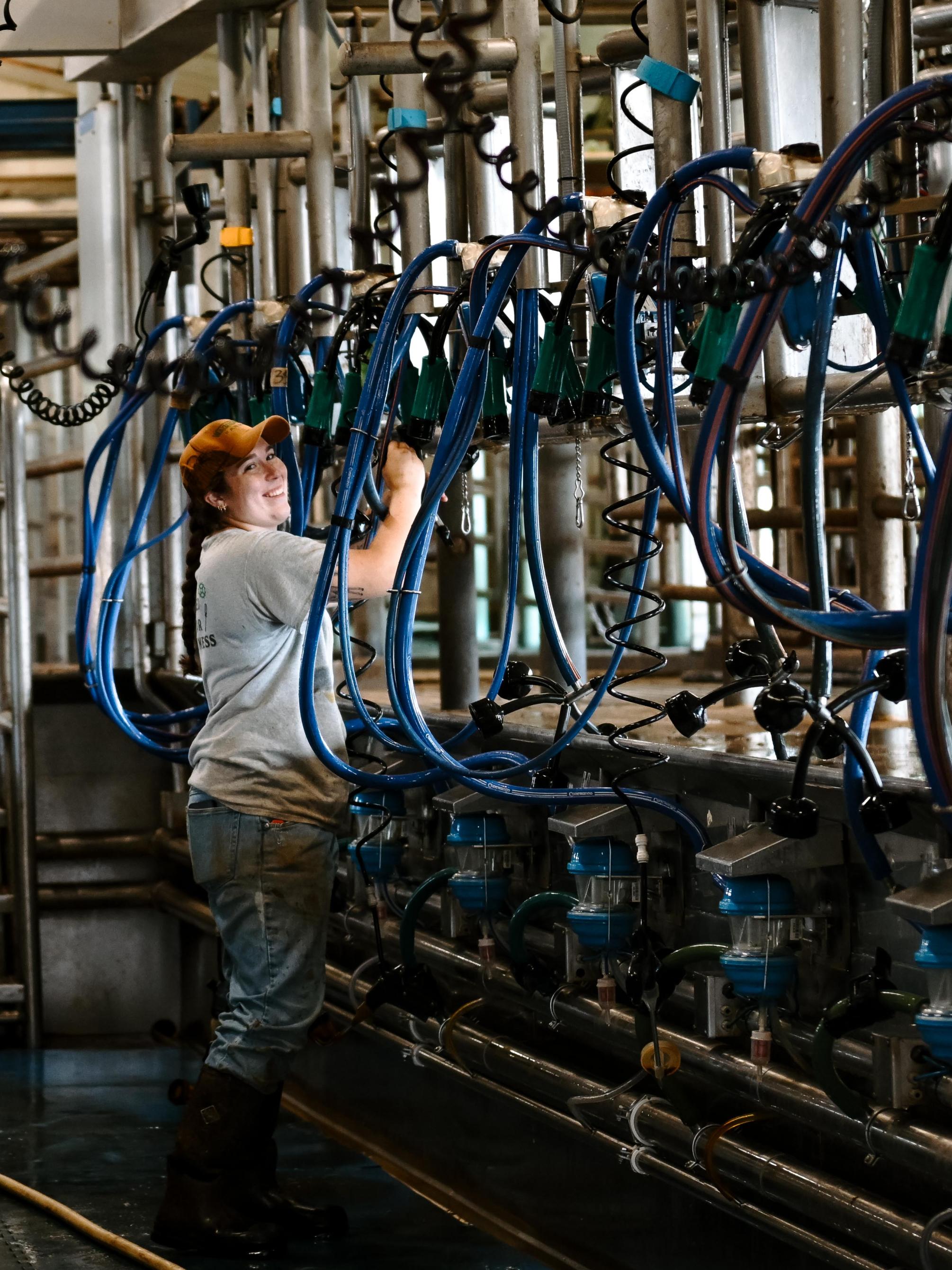 A student works on machinery in a barn