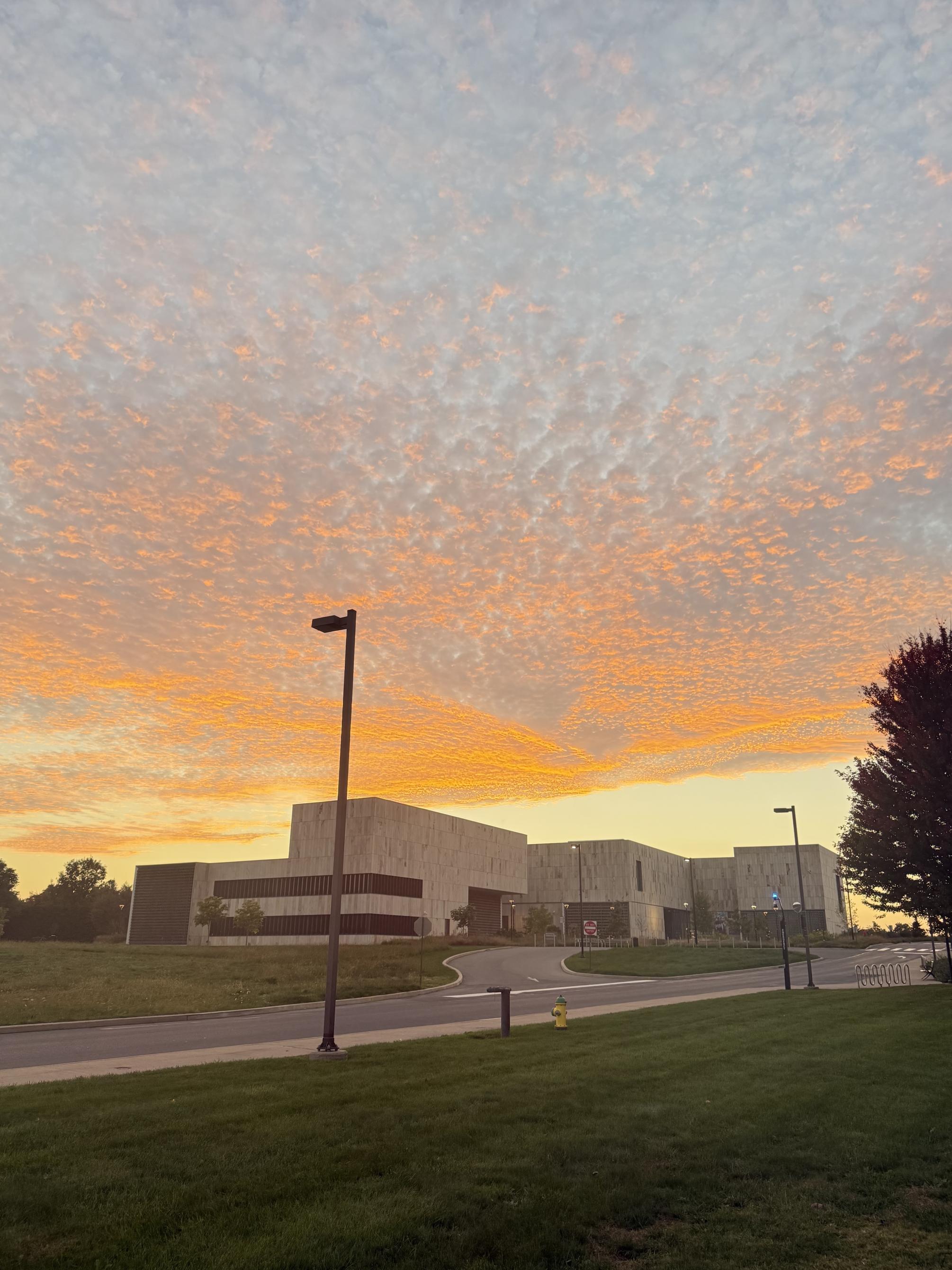 Orange sunset with billowing clouds over the Palmer Museum.
