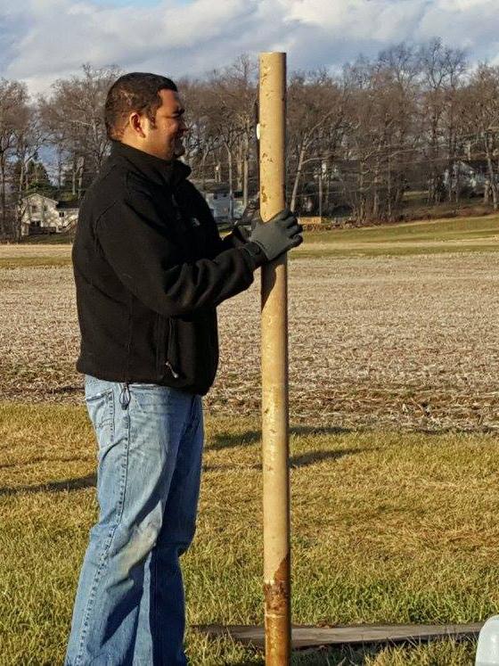 student holding metal pole