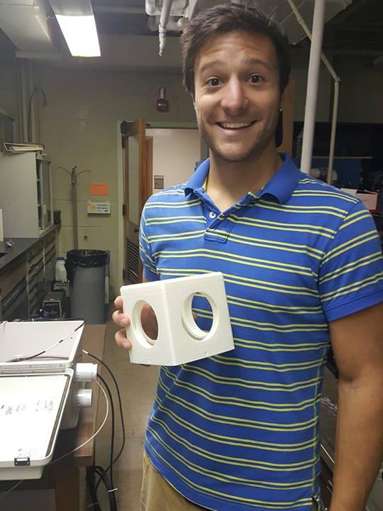 student holding 3d-printed cube