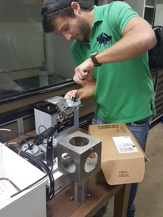 Energy engineering student Matthew Callen attaches a sensor to a metal plate for the group’s All-Seeing Eye device.