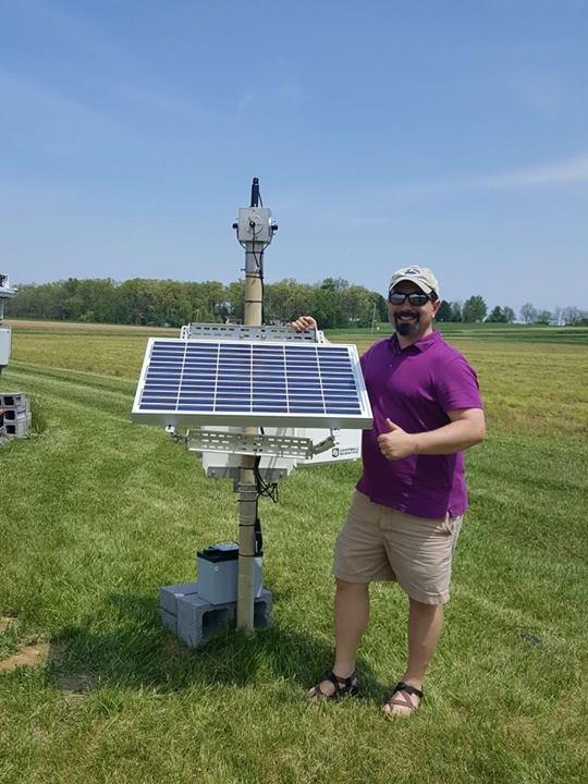 Professor Jeffrey Browson stands next to the completed All-Seeing Eye.