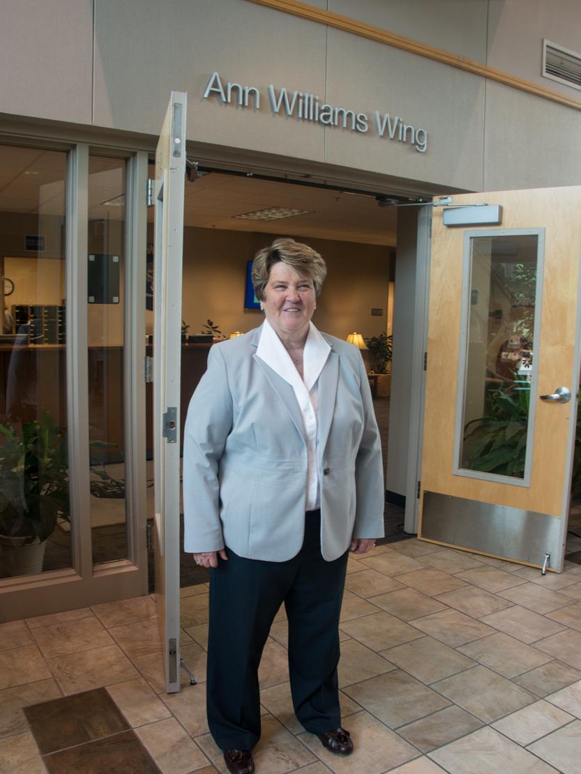 Dr. Ann Williams stands in front of the wing named after her.
