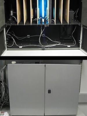 A small metallic cabinet-like reactor is shown on the floor with some blue light.