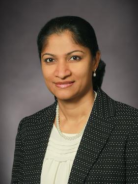 A portrait of a woman smiling at the camera
