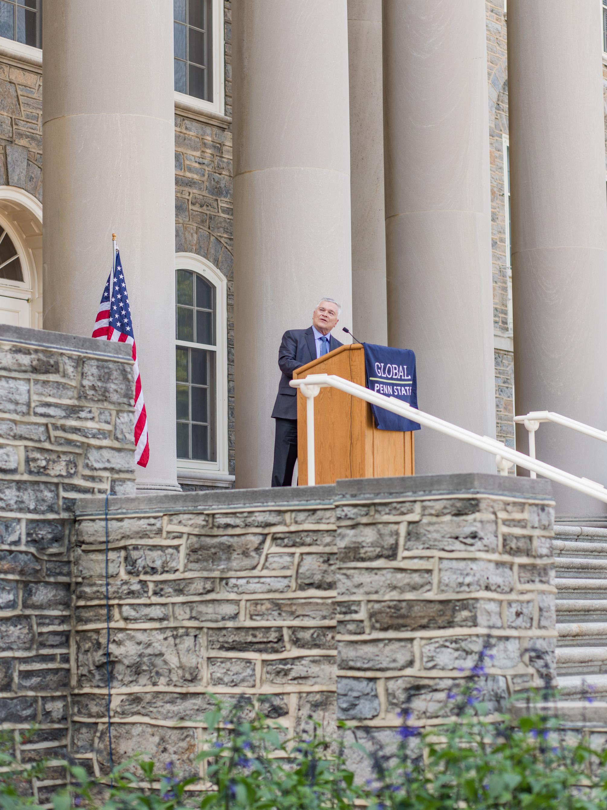 President Eric Barron speaking behind a podium