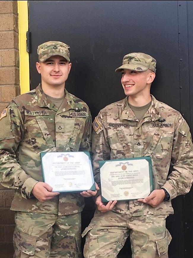 Brandon Sicovitch and a friend pose with honorary certificates they received