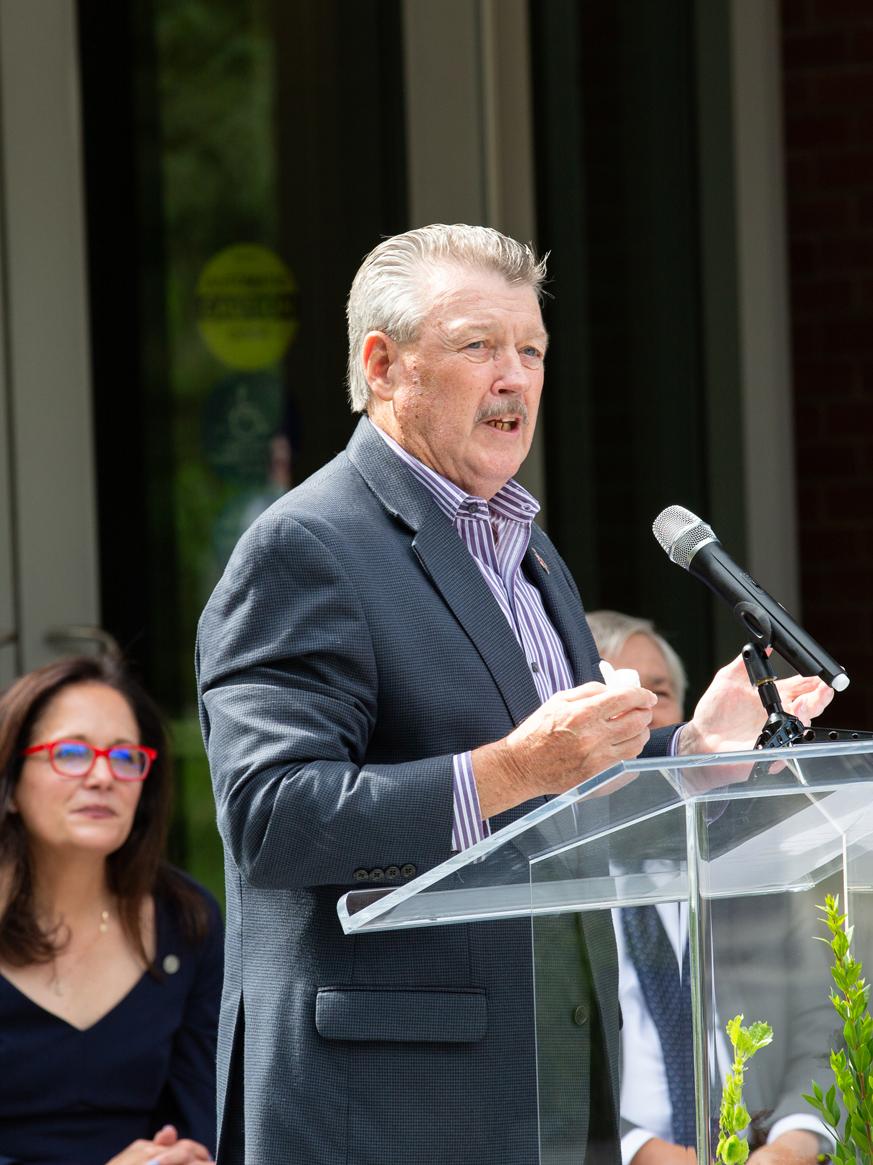 Man standing at podium talking into a microphone. 