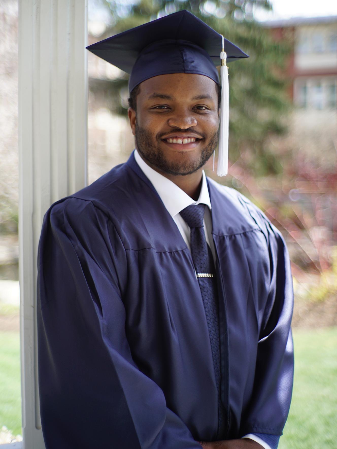 Brian Davis in a cap and gown at Penn State graduation