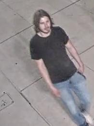A suspect from surveillance video wears blue jeans and a black T-shirt