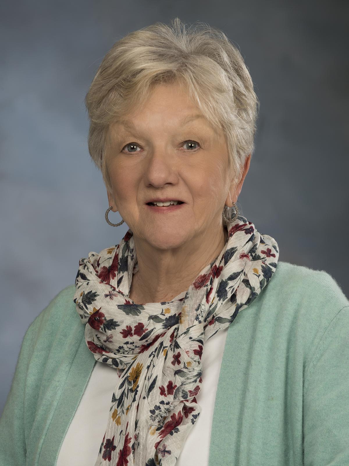 head shot of woman with scarf