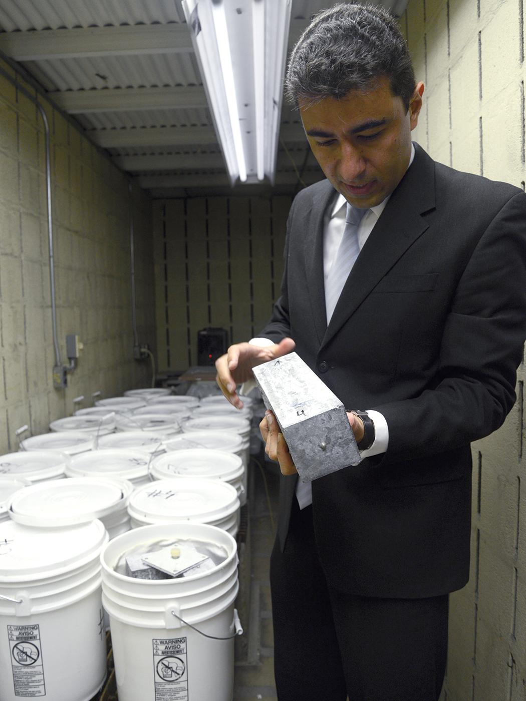 an engineer examines a concrete prism