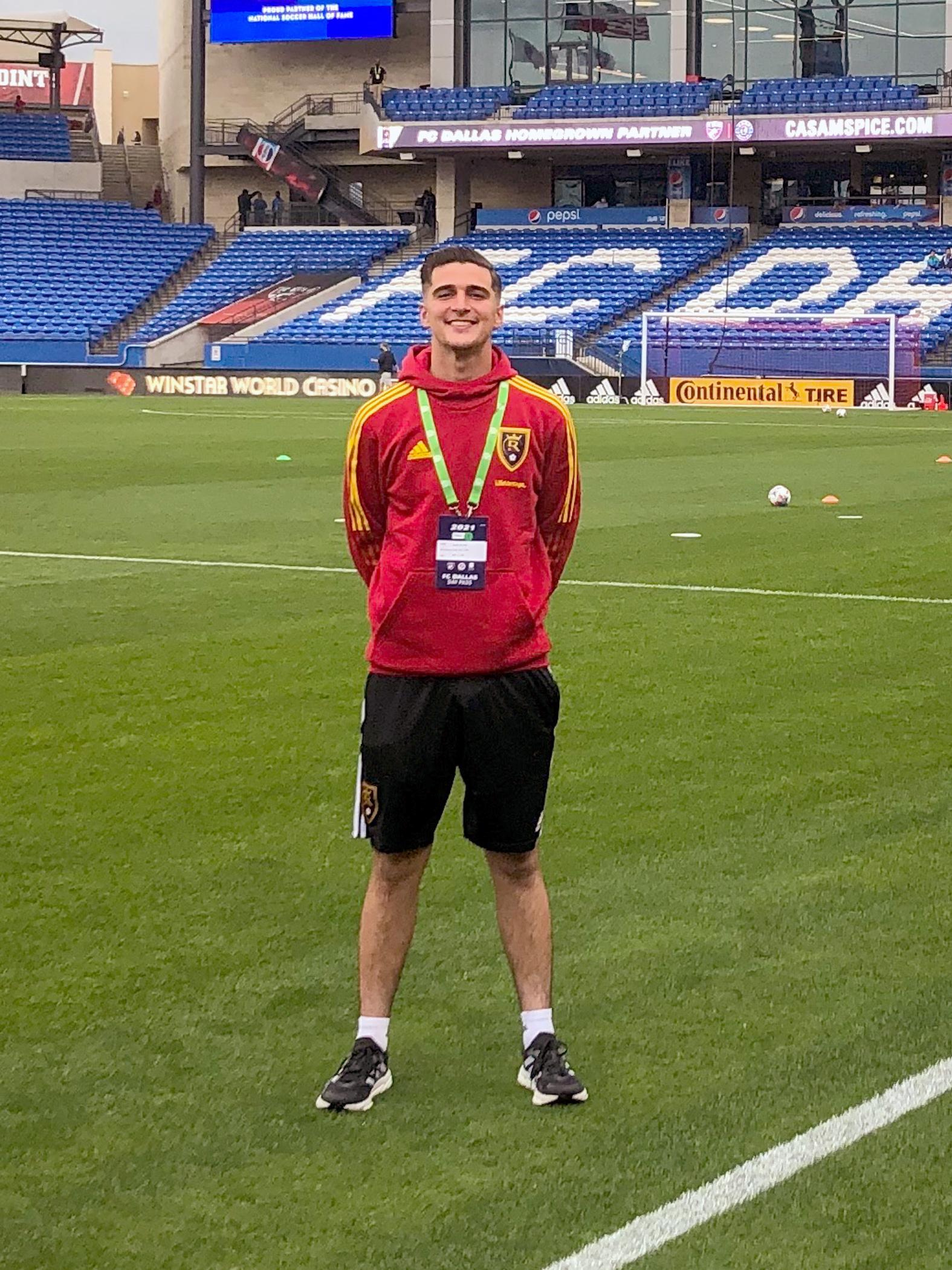 Christian Peters standing on a soccer field.