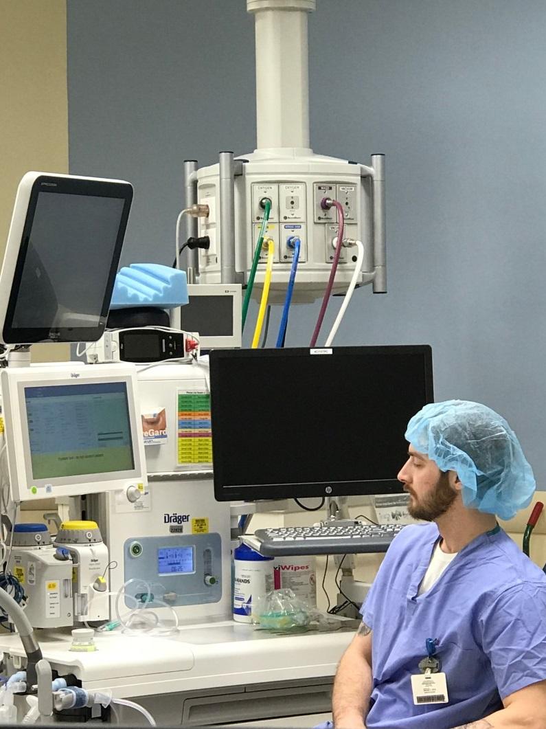 Man sits near hospital equipment
