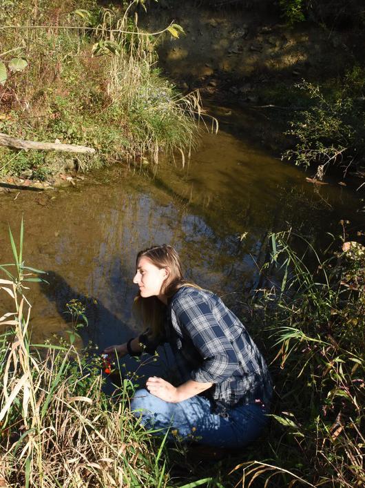 Penn State junior Kelly Asselin takes pH and temperature readings