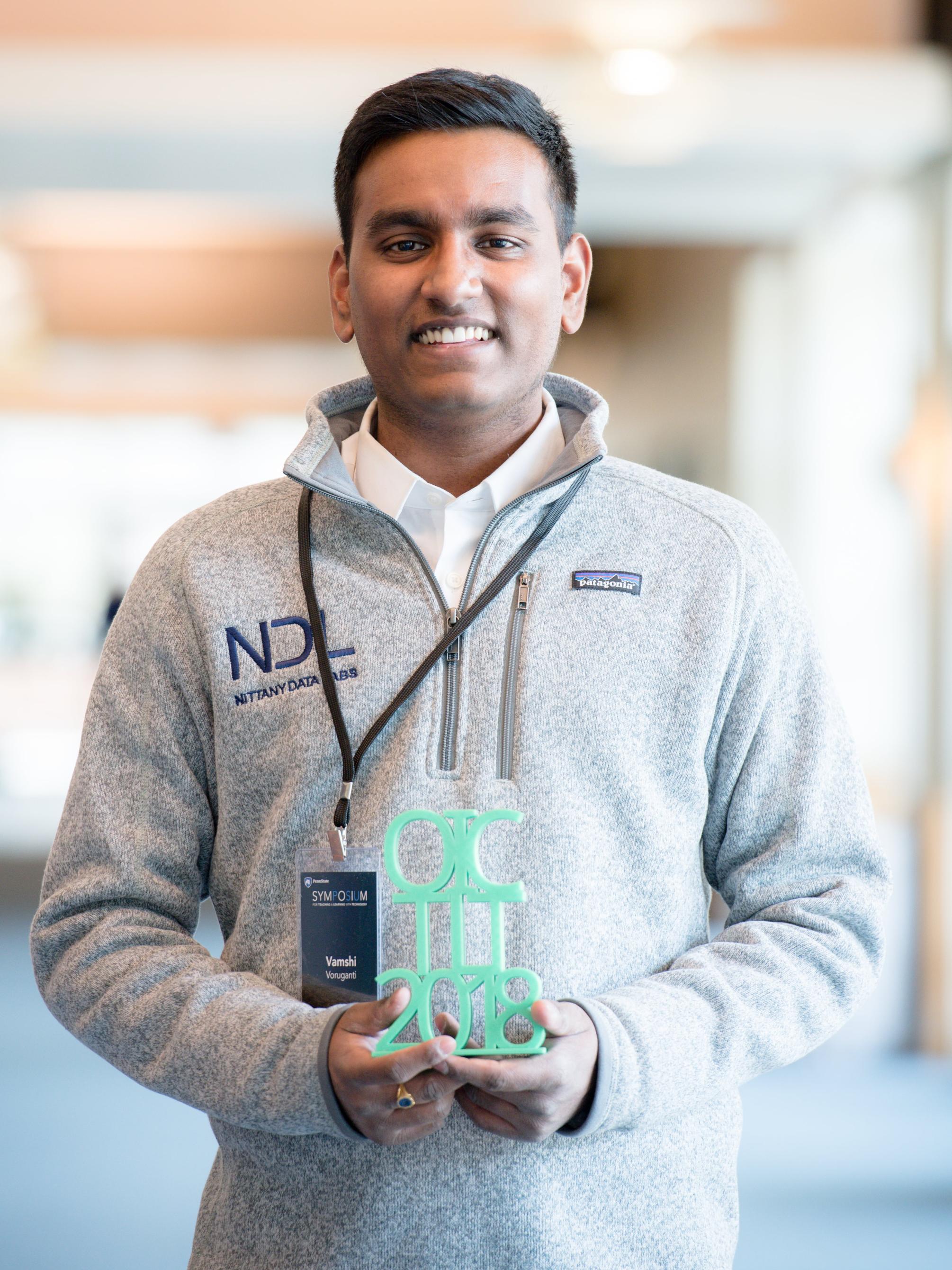 Vamshi holds 3-D printed Open Innovation Challenge award 