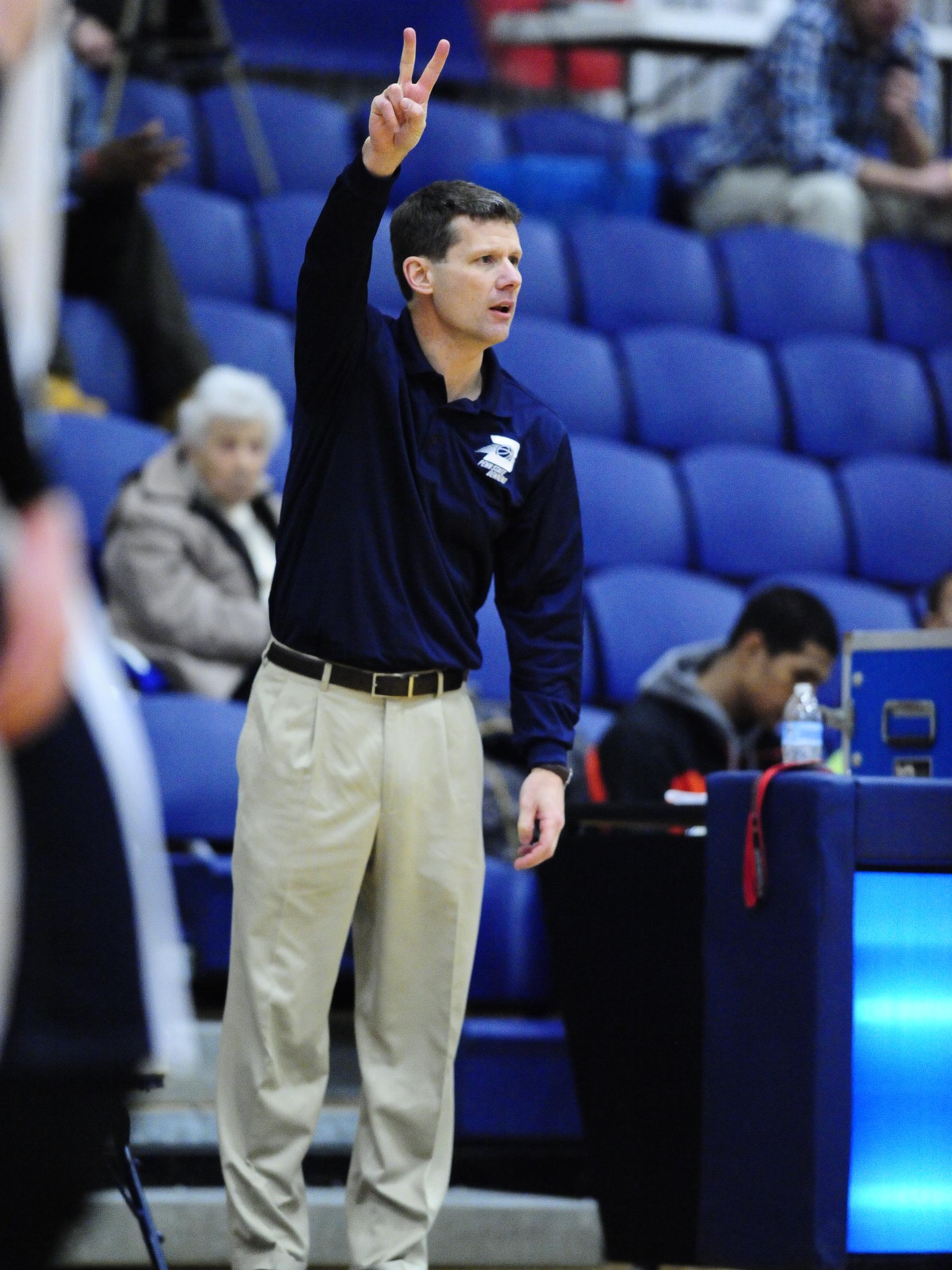 Head coach Dave Niland on the court with Penn State Behrend's basketball team
